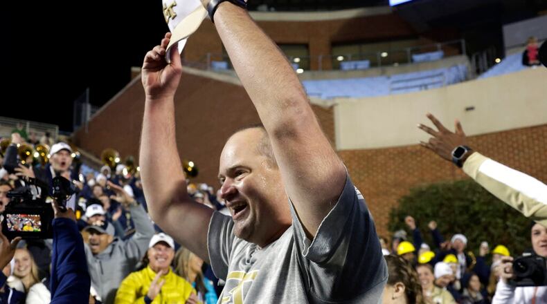 Georgia Tech interim head coach Brent Key celebrates with fans after the team defeated North Carolina in an NCAA college football game, Saturday, Nov. 19, 2022, in Chapel Hill, N.C. (AP Photo/Chris Seward)