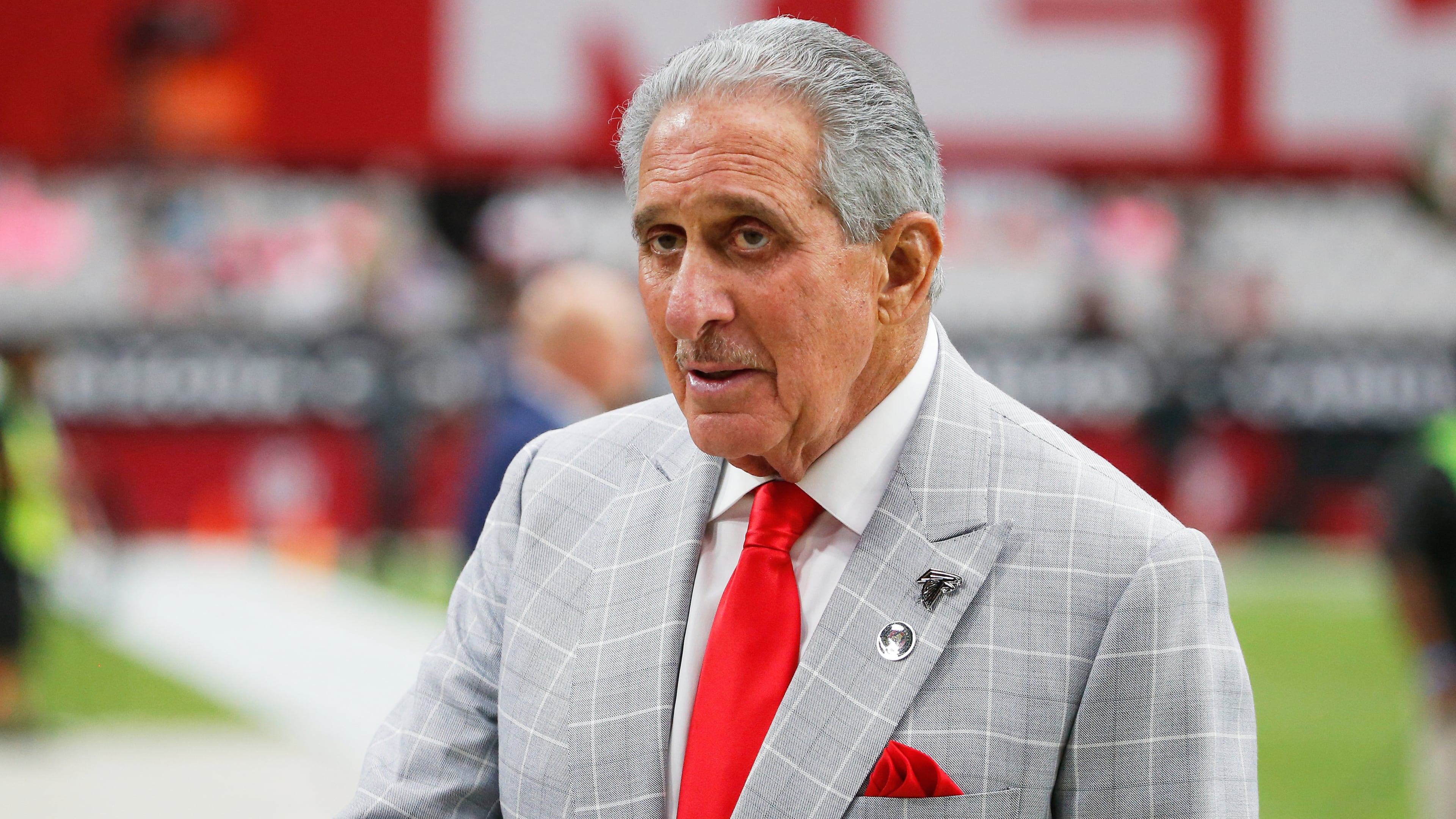 FILE - Atlanta Falcons owner Arthur Blank stands on the field prior to an NFL football game against the Arizona Cardinals, Oct. 13, 2019, in Glendale, Ariz. (AP Photo/Rick Scuteri, File)