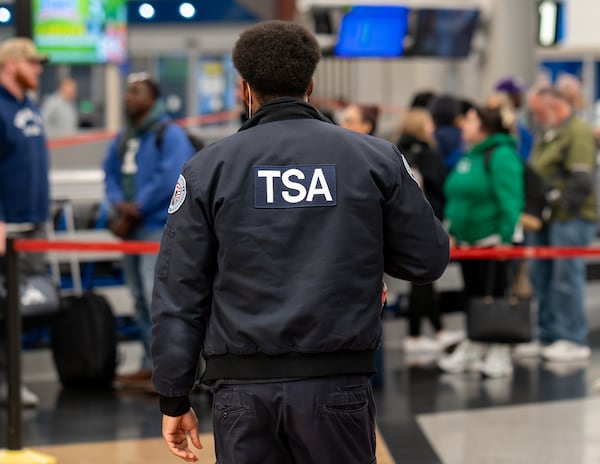 A TSA Officer keeps an eye on the situation at the North terminal at Hartsfield-Jackson Wednesday. (Ben Hendren for the AJC)
