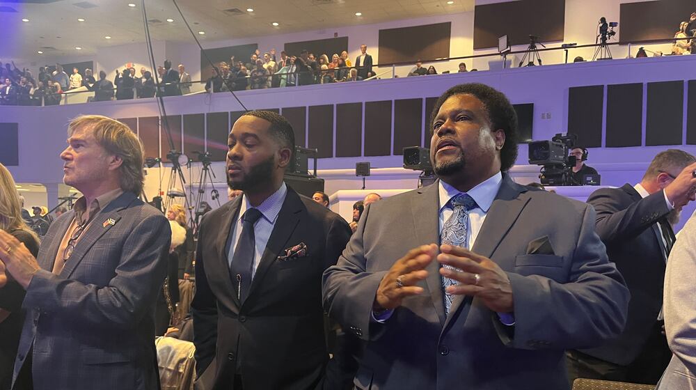 Minister Michael Lindell of Atlanta, center, and Pastor Enos Chamberlain of Columbia, Missouri, right, gather with supporters of former President Donald Trump last week at the inaugural National Faith Summit in Powder Springs.