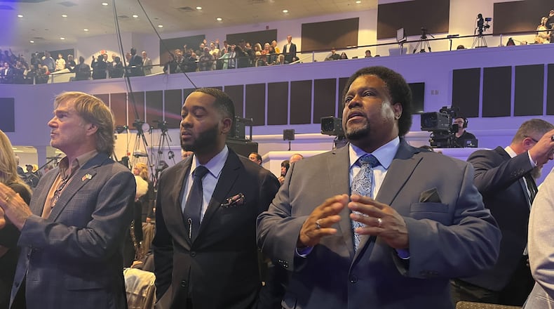 Minister Michael Lindell of Atlanta, center, and Pastor Enos Chamberlain of Columbia, Missouri, right, gather with supporters of former President Donald Trump last week at the inaugural National Faith Summit in Powder Springs.