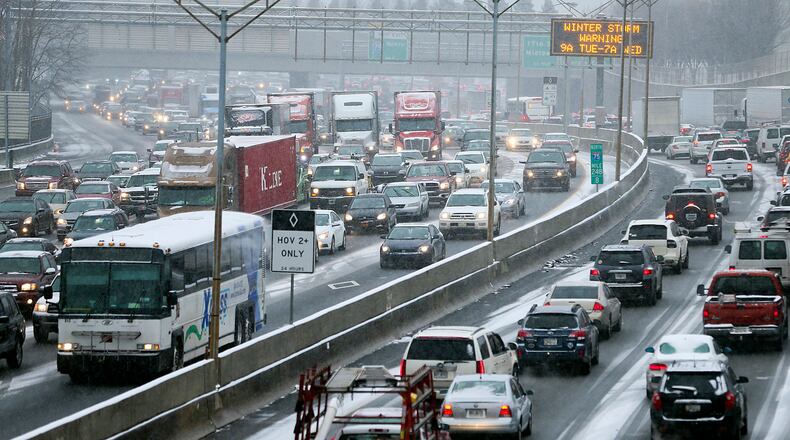 Jan. 28, 2014 Atlanta: Traffic was grid locked on the connector Tuesday afternoon, Jan. 28, 2014 as many employers let their employees off all at the same time. The winter storm that paralyzed metro Atlanta and other parts of Georgia prompted Gov. Nathan Deal to declare a state of emergency Tuesday afternoon, Jan.28, 2014 for all 159 counties. In a matter of hours, snow blanketed the area. But any hopes of a winter wonderland were dashed by a more miserable reality. Take rush-hour traffic in Atlanta, add inches of slushy, slick mess and the result is gridlock on interstates in all directions. For hours, roads and interstates have remained jammed stranding some drivers, and there were too many wrecks to count Tuesday afternoon as a winter storm continued to dump snow across metro Atlanta. Many school systems dismissed early, sending some parents scrambling home. Others seemed to hit the roads, too. But it was anything but a typical commute, even by Atlanta standards. Drivers reported commutes of more than three hours. Some school buses couldn’t run routes and were forced to return to schools. And teachers and students were faced Tuesday afternoon with the real possibility of spending the night in the classroom. JOHN SPINK/JSPINK@AJC.COM
