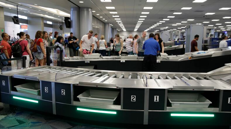 In this Sept. 1, 2017, photo, people use newly installed automated security lanes at McCarran International airport Friday, Sept. 1, 2017, in Las Vegas. Three reconfigured security lanes are equipped with upgraded features, including bins that are 25 percent larger and capable of holding roll-aboard luggage.
(AP Photo/John Locher)