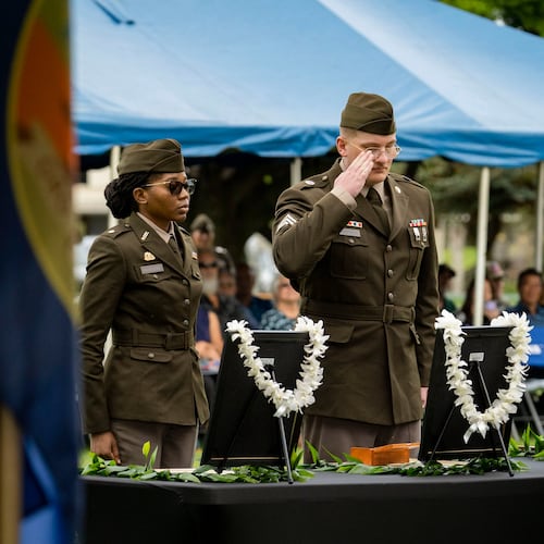 U.S. Army soldiers salute framed photos of former University of Hawaii ROTC cadets during a posthumous commissioning ceremony at Ke'ehi Lagoon Memorial Park, Monday, Jan. 26, 2026, in Honolulu. (AP Photo/Mengshin Lin)