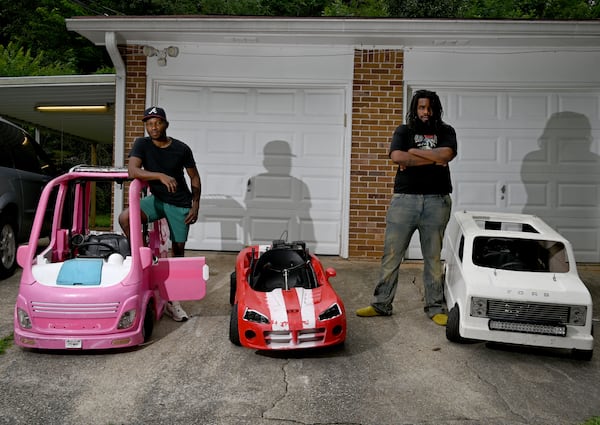 Mali “Sota” Hightower (left) and Marvelous Garvey modify kids' cars into gas-powered minicars in Ellenwood. The Barbie camper is the eighth in a collection. (Hyosub Shin/AJC)
