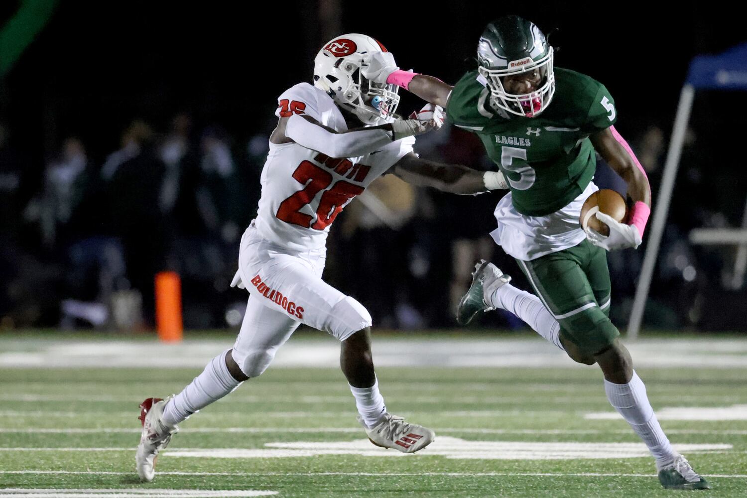 Collins Hill wide receiver Sean Norris (5) runs against North Gwinnett defensive back Kenan Holmes (26) after a catch. JASON GETZ FOR THE ATLANTA JOURNAL-CONSTITUTION