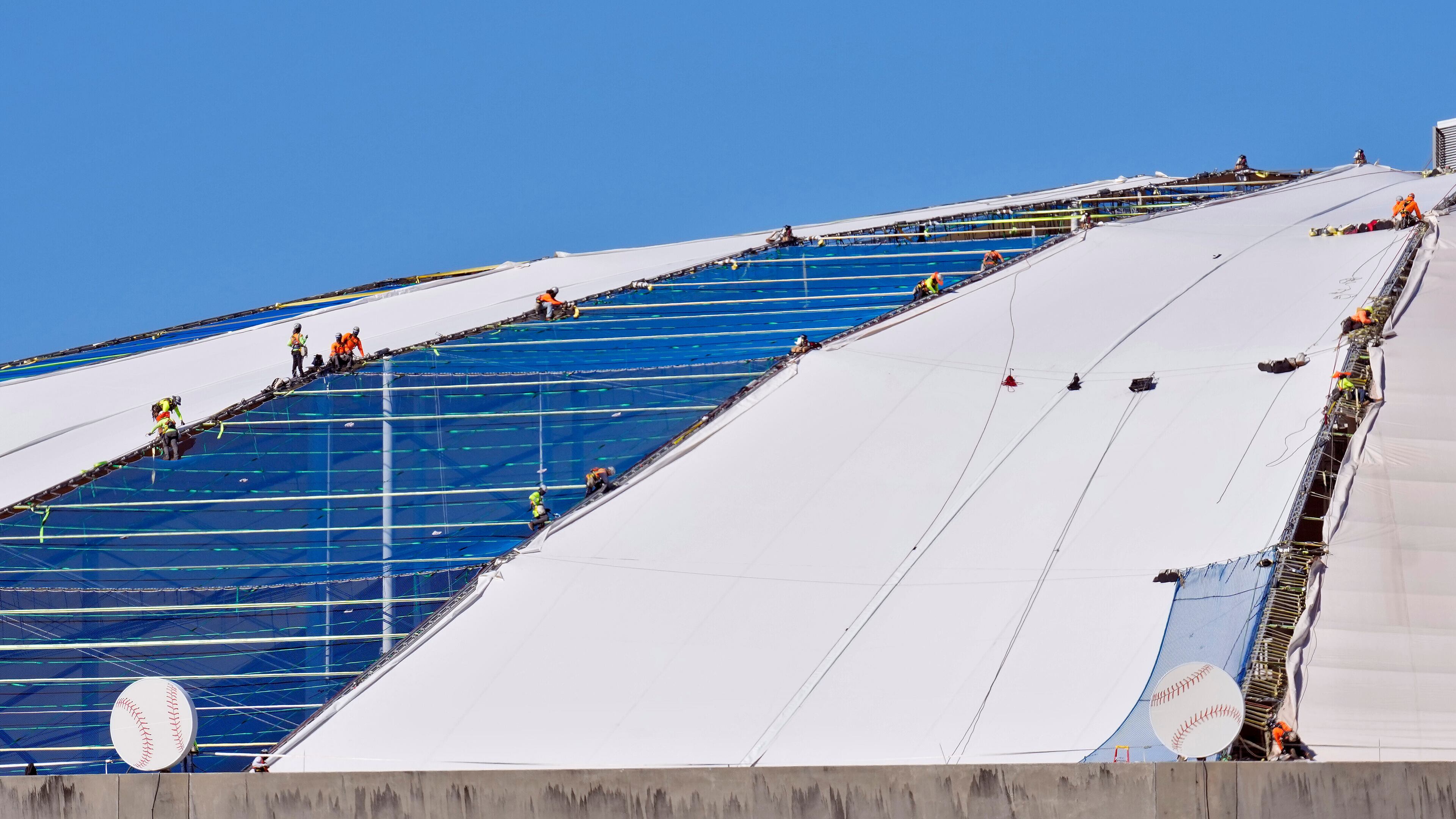 Workers continue to repair the panels on the roof of Tropicana Field Monday, Nov. 3, 2025, in St. Petersburg, Fla. The roof was destroyed by Hurricane Milton in 2024. (AP Photo/Chris O'Meara)