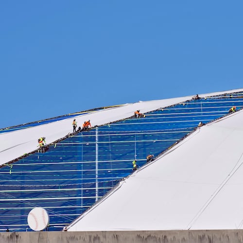 Workers continue to repair the panels on the roof of Tropicana Field Monday, Nov. 3, 2025, in St. Petersburg, Fla. The roof was destroyed by Hurricane Milton in 2024. (AP Photo/Chris O'Meara)