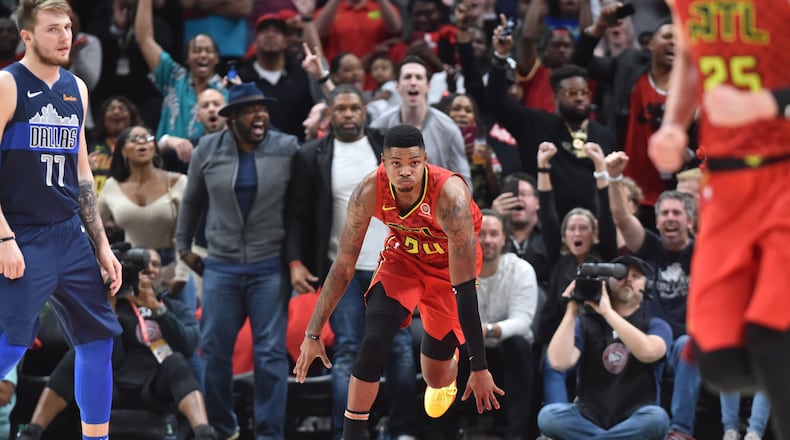 Hawks guard Kent Bazemore (24) celebrates after he scored during the second half of the home opener in an NBA basketball game at State Farm Arena on Wednesday, October 24, 2018. HYOSUB SHIN / HSHIN@AJC.COM