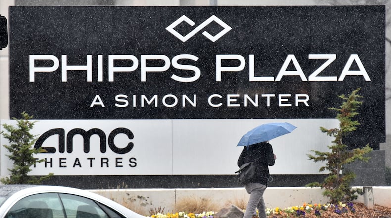 January 6, 2017 Atlanta - A pedestrian with an umbrella makes her way near Phipps Plaza in Buckhead on Friday, January 6, 2017. The Belk store at the posh Buckhead mall is expected to close in the summer. HYOSUB SHIN / HSHIN@AJC.COM