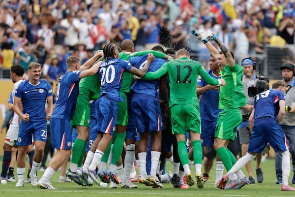 Chelsea's players celebrate after winning the Club World Cup final soccer match between against PSG in East Rutherford, N.J., Sunday, July 13, 2025. (AP Photo/Adam Hunger)