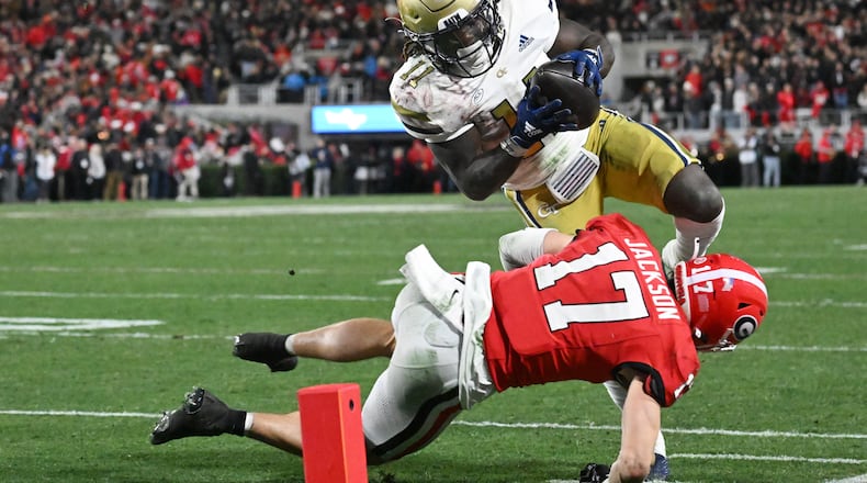 Two former Georgia high school players collide in the Georgia-Georgia Tech game last month.  Georgia Tech running back Jamal Haynes (11) of North Gwinnett catches and runs for a touchdown as Dan Jackson of North Hall tries to make a tackle at Sanford Stadium, Friday, November 29, 2024, in Athens. (Hyosub Shin / AJC)