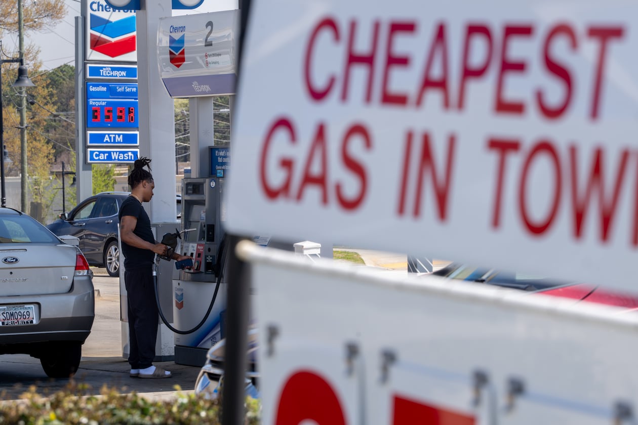 A driver fuels up at a gas station in Marietta on Friday, March 20, 2026. Road trippers should plan fill-ups around cheaper gas stops instead of randomly pulling off the highway when the fuel light illuminates, Doug Turnbull writes. (Ben Hendren for the AJC)