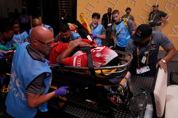 Bayern Munich's Jamal Musiala is taken off the field after an injury during the Club World Cup quarterfinal soccer match between PSG and Bayern Munich in Atlanta, Saturday, July 5, 2025. (AP Photo/Brynn Anderson)