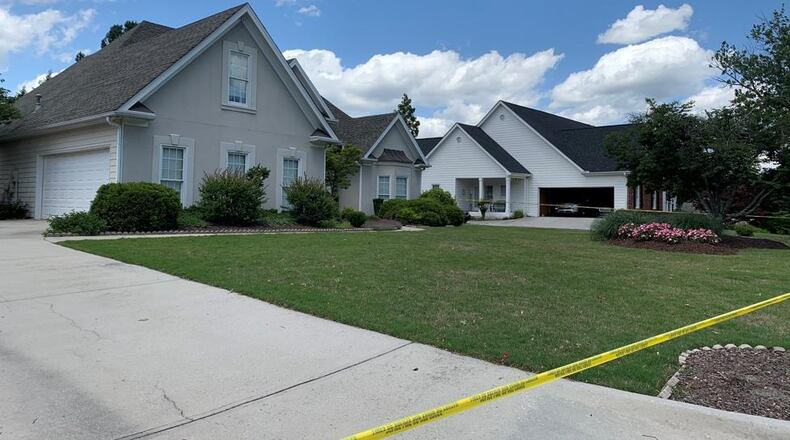 The bodies were discovered inside a house off Highland Ridge Point in unincorporated Lawrenceville.