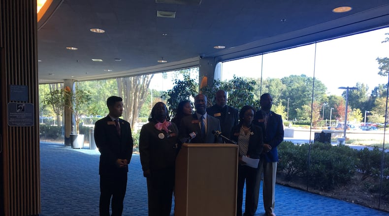 Members of the Georgia Legislative Black Caucus, including Rep. William Boddie (center), held a press conference Thursday at the Gwinnett Justice and Administration Center to speak against Gwinnett County’s disproportionate rate of rejected absentee ballots. AMANDA COYNE / AMANDA.COYNE@AJC.COM
