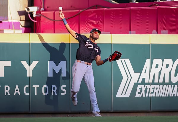 Washington Nationals outfielder James Wood throws after making a catch at the wall in the first inning of a baseball game against the Atlanta Braves, Monday, May 12, 2025, in Atlanta. (AP Photo/Colin Hubbard)