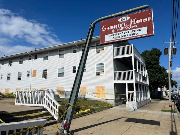 Boards cover the windows of the Gabriel House assisted living facility, where a fire on Sunday killed several people, Tuesday, July 15, 2025 in Fall River, Mass. (AP Photo/Kimberlee Kruesi)