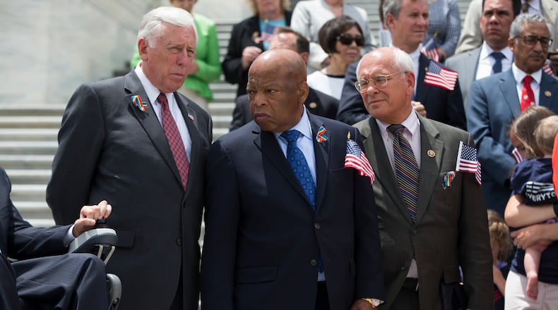 Rep. John Lewis, D-Ga., , flanked by House Minority Whip Steny Hoyer of Md., left, and Rep. Paul Tonko, D-N.Y., participate in a news conference on gun legislation, Wednesday, June 22, 2016, on Capitol Hill in Washington. (AP Photo/Evan Vucci)