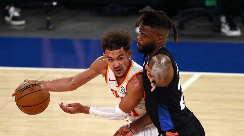 Atlanta Hawks' Trae Young, left, tries to get past New York Knicks' Reggie Bullock during the fourth quarter in Game 2 in an NBA basketball first-round playoff series Wednesday, May 26, 2021, in New York. (Elsa/Pool Photo via AP)