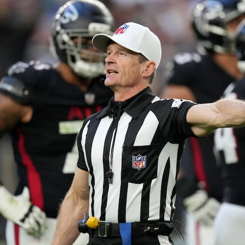 FILE - Referee Land Clark annouces a penalty during the second half of an NFL football game between the Arizona Cardinals and the Atlanta Falcons Sunday, Dec. 21, 2025, in Glendale, Ariz. (AP Photo/Ross D. Franklin, File)