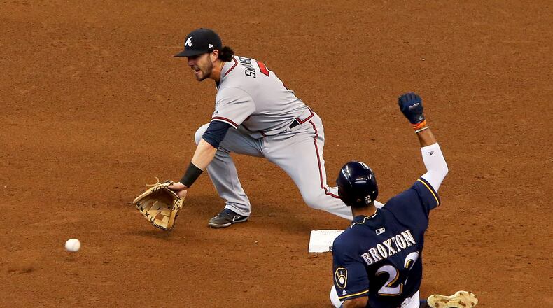Keon Broxton steals second base past Dansby Swanson during the fifth inning of Sunday's game.