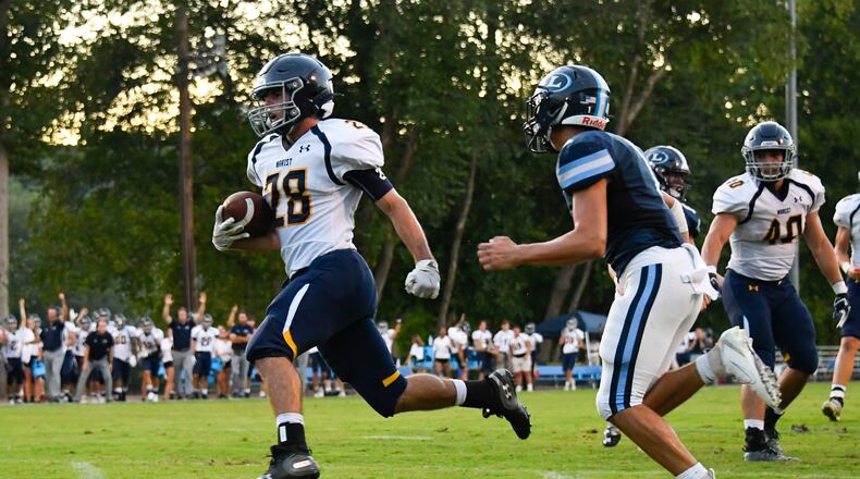 Marist RB Brett Zoeller (28) breaks away for a touchdown as Lovett's Peyton Ringer defends during Friday's game at Lovett. (John Amis/Special)