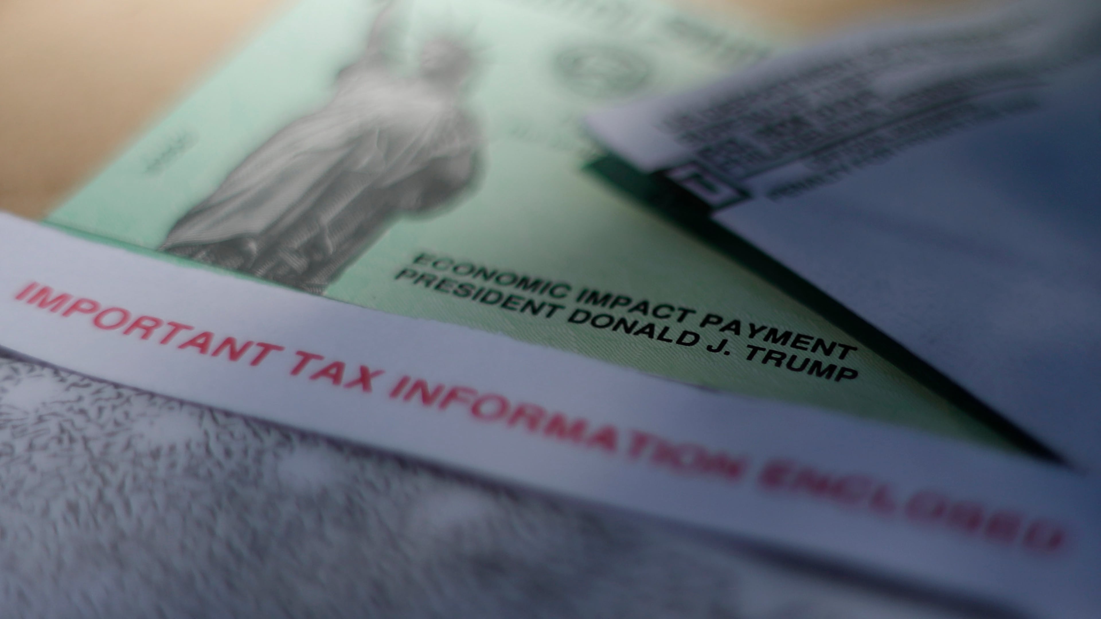 FILE - President Donald J. Trump's name is printed on a stimulus check issued by the IRS to help combat the adverse economic effects of the new coronavirus outbreak in San Antonio, April 23, 2020. (AP Photo/Eric Gay, File)