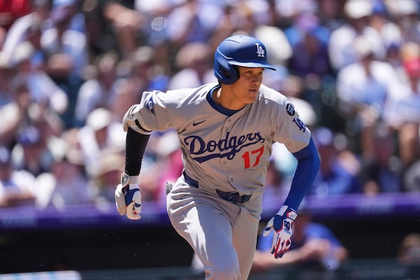 Los Angeles Dodgers' Shohei Ohtani heads up the first base line after grounding out against Colorado Rockies starting pitcher Austin Gomber in the fifth inning of a baseball game Thursday, June 26, 2025, in Denver. (AP Photo/David Zalubowski)