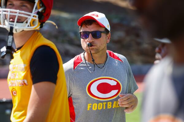 Baseball and football assistant coach Jack Mangel (center) watches football practice at Clarke Central in Athens on Tuesday, July 7, 2026. He was coach David Perno’s first quarterback at Clarke Central in 2016. (Arvin Temkar/AJC)