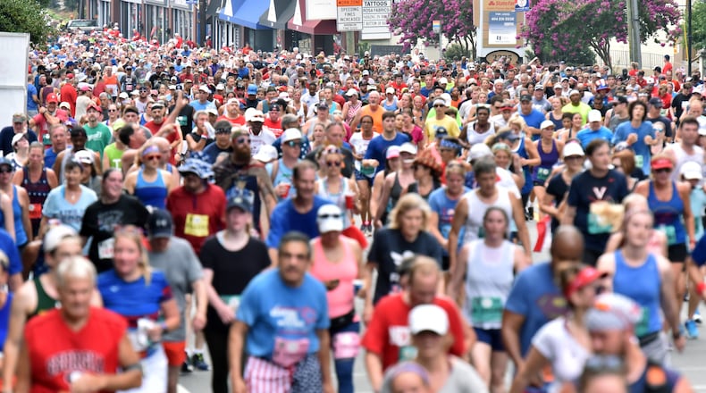 Runners make their way down Peachtree Road during the 50th AJC Peachtree Road Race on Thursday, July 4, 2019, in Atlanta.