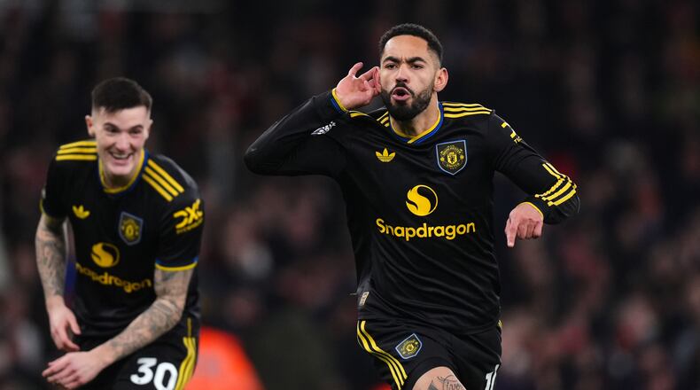 Manchester United's Matheus Cunha celebrates scoring their side's third goal of the game during the English Premier League soccer match between Arsenal and Manchester United in London, Sunday, Jan. 25, 2026. (Mike Egerton/PA via AP)