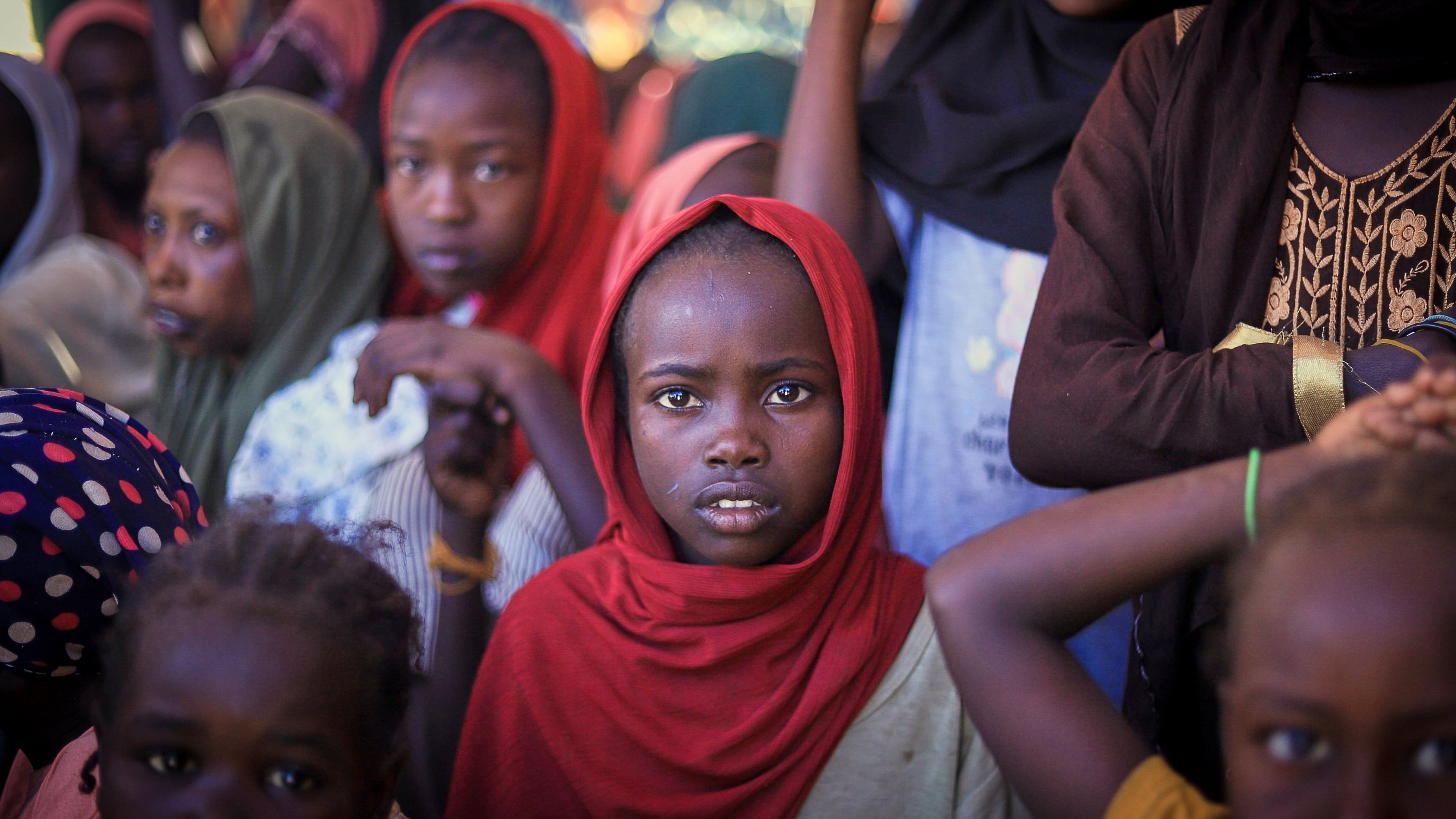 This photo released by The Norwegian Refugee Council (NRC), shows displaced women and children from el-Fasher at a camp where they sought refuge from fighting between government forces and the RSF, in Tawila, Darfur region, Sudan, Monday, Nov. 3, 2025. (Marwan Mohammed/NRC via AP)