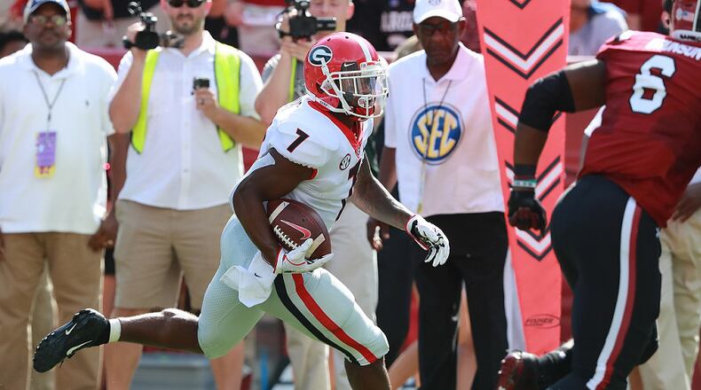 Georgia running back D'Andre Swift breaks away from South Carolina defender T.J. Brunson for a touchdown Saturday, Sept 8, 2018, in Columbia. Curtis Compton / ccompton@ajc.com