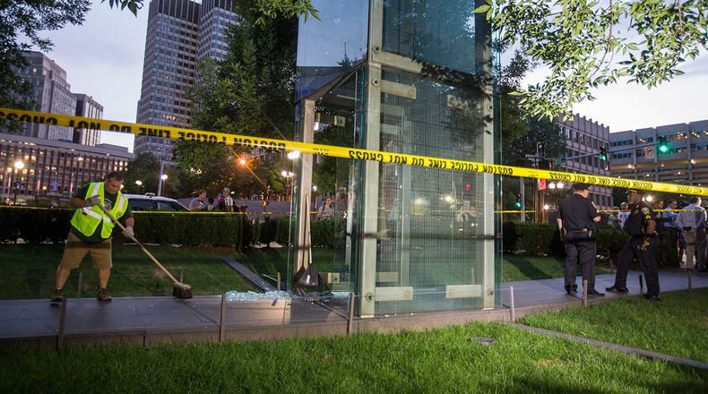 BOSTON, MA - AUGUST 14: A worker cleans up broken glass at the New England Holocaust Memorial that was vandalized when a rock was thrown through a panel that was part of it on August 14, 2017 in Boston, Massachusetts. (Photo by Scott Eisen/Getty Images)