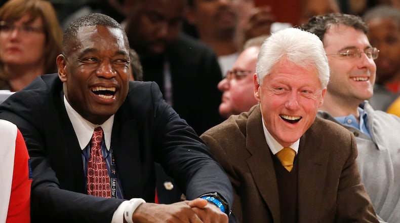 Former President Bill Clinton, right, sits with former NBA basketball player Dikembe Mutombo during the first half of the NBA All-Star game, Sunday, Feb. 15, 2015, in New York. (AP Photo/Kathy Willens)