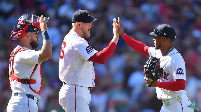 Boston Red Sox's Connor Wong, left, Ryan Watson, center, and Ceddanne Rafaela, right, celebrate after their team's win over the Tampa Bay Rays in a baseball game, Sunday, July 19, 2026, in Boston. (AP Photo/Steven Senne)