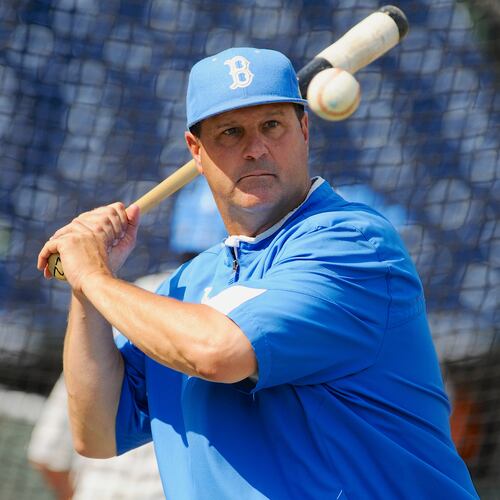 FILE - UCLA coach John Savage eyes the ball during NCAA college baseball practice June 14, 2013, in Omaha, Neb. (AP Photo/Eric Francis, File)