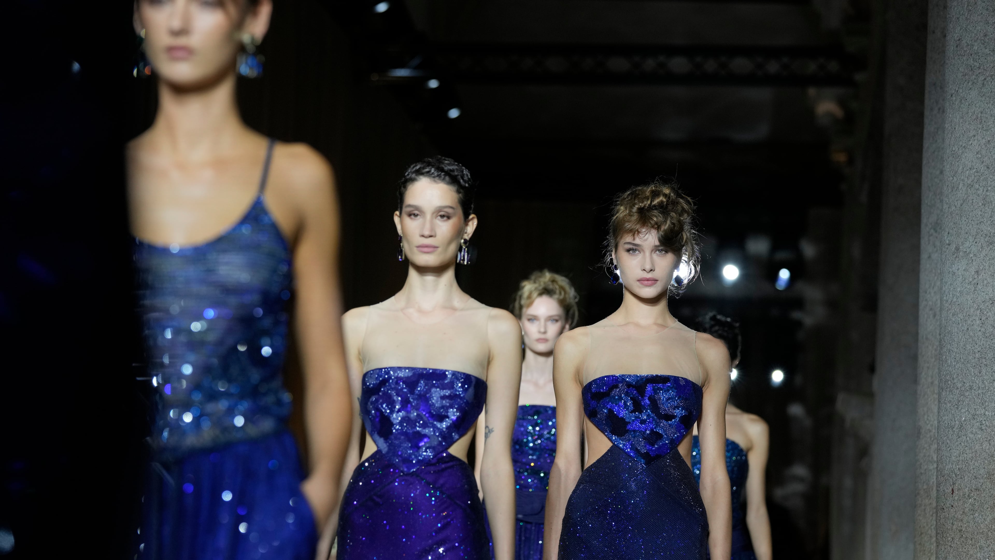 Models wear creations as part of the Giorgio Armani Spring/Summer 2026 collection show in Milan, Italy, Sunday, Sept. 28, 2025. (AP Photo/Luca Bruno)