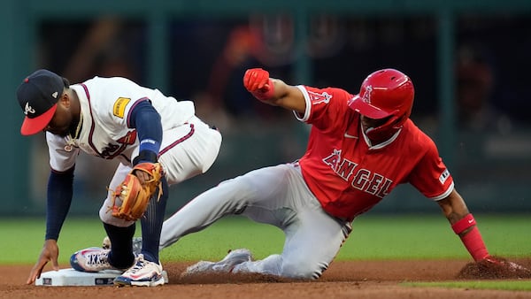 Atlanta Braves second baseman Ozzie Albies (1) tages Los Angeles Angels' Christian Moore (4) out at second in the fourth inning of a baseball game, Wednesday, July 2, 2025, in Atlanta. (AP Photo/Mike Stewart)