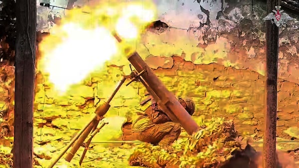 In this photo taken from video distributed by Russian Defense Ministry Press Service on Tuesday, April 8, 2025, Russian 120mm mortar crew fire toward Ukrainian position at an undisclosed location in Ukraine. (Russian Defense Ministry Press Service via AP)