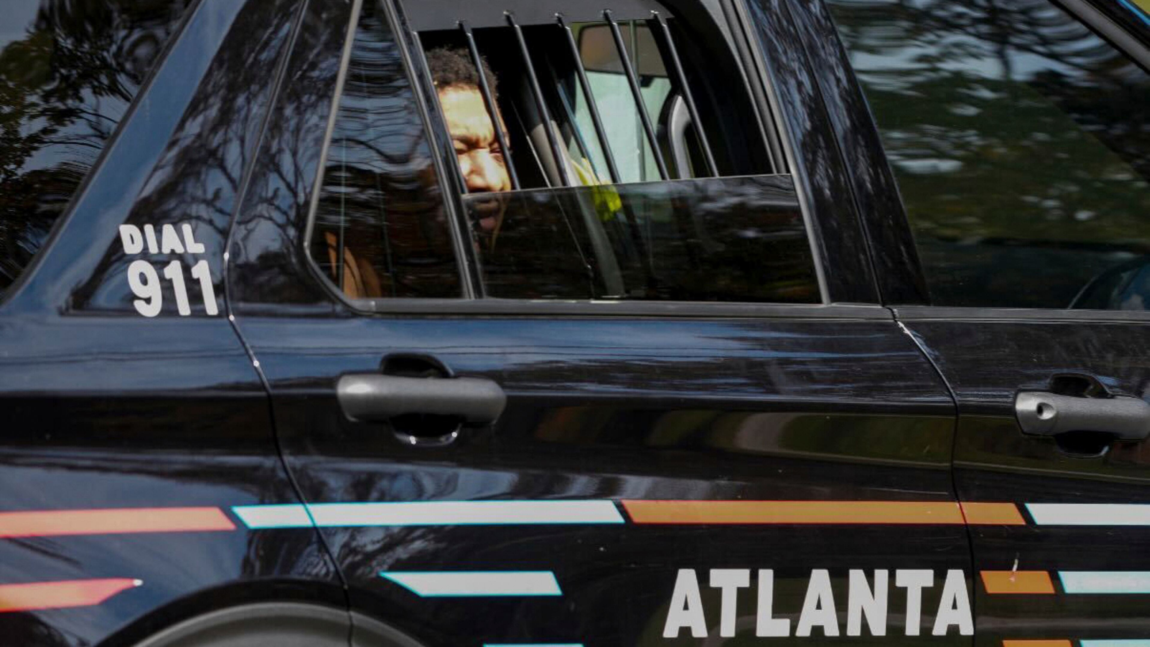 Derrick Groves, the last escapee from the New Orleans jailbreak in May, sits in a police vehicle after being taken into custody by U.S. Marshals and Atlanta police at a southwest Atlanta home, Wednesday, Oct. 8, 2025. (Ben Hendren/Atlanta Journal-Constitution via AP)