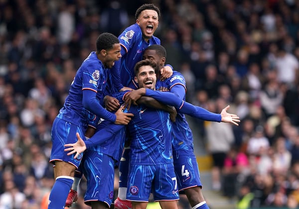 Chelsea's Pedro Neto, center, celebrates scoring his side's second goal of the game with teammates, during the English Premier League soccer match between Fulham and Chelsea, at Craven Cottage, London, Sunday April 20, 2025. (Jonathan Brady/PA via AP)