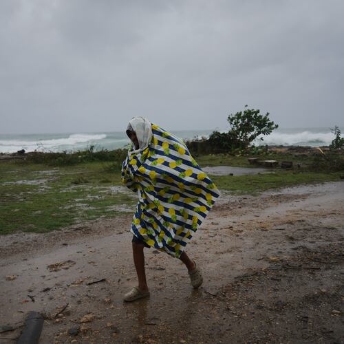 A man walks in the rain before the arrival of Hurricane Melissa in Canizo, a village in Santiago de Cuba, Tuesday, Oct. 28, 2025. (AP Photo/Ramón Espinosa)