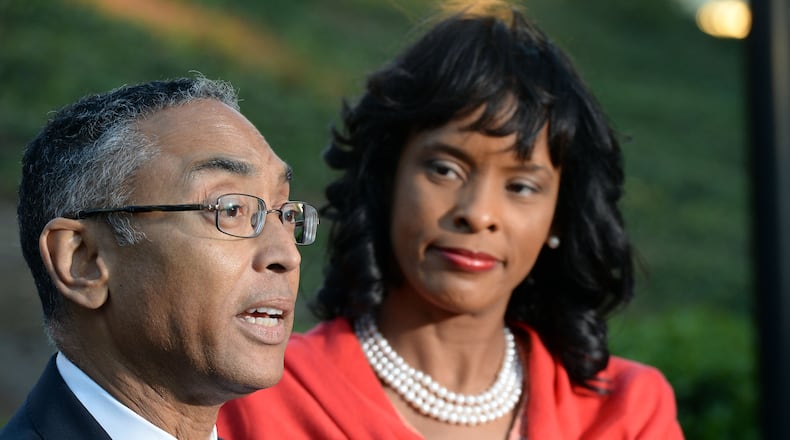 DeKalb CEO Burrell Ellis, with his wife Philippa, speaks during a press conference Thursday for the first time since he was convicted a year and a half ago following a second trial in DeKalb County. The Georgia Supreme Court threw out Ellis’ guilty verdicts on Wednesday. KENT D. JOHNSON/kdjohnson@ajc.com