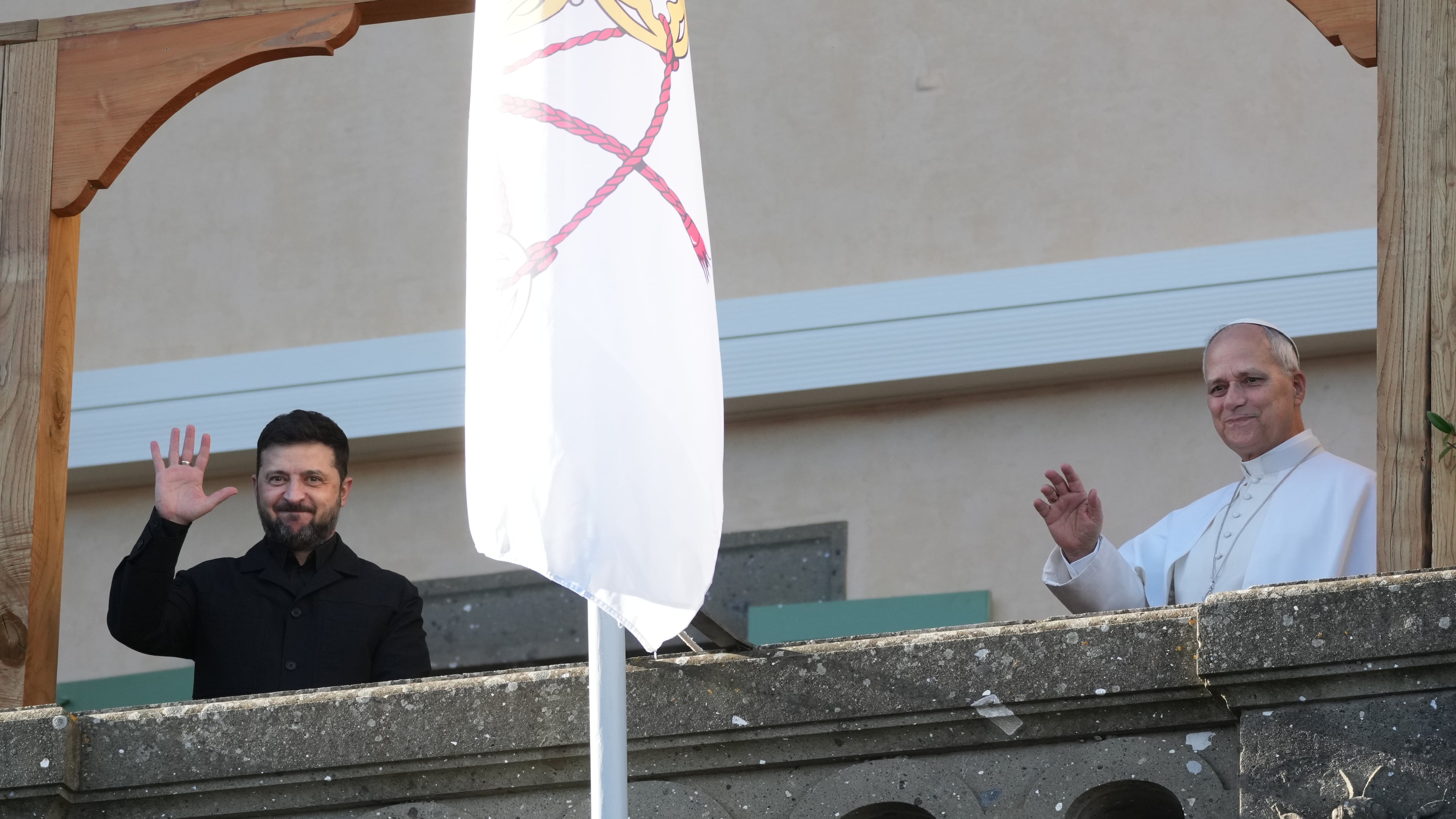 Ukraine's President Volodymyr Zelenskyy and Pope Leo XIV wave to journalists during their meeting in Castel Gandolfo, Italy, Tuesday, Dec. 9, 2025. (AP Photo/Andrew Medichini)