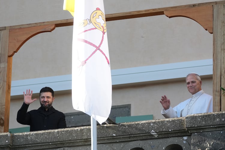 Ukraine's President Volodymyr Zelenskyy and Pope Leo XIV wave to journalists during their meeting in Castel Gandolfo, Italy, Tuesday, Dec. 9, 2025. (AP Photo/Andrew Medichini)