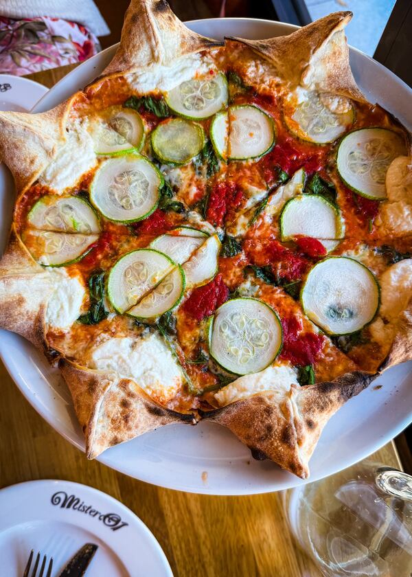 Mister O1 Extraordinary Pizza is known for its star-shaped pies, which include little pockets of ricotta in the crust. The Star Michele (pictured) is a vegetarian pizza that includes spinach, zucchini and roasted red pepper puree. (Henri Hollis/AJC)