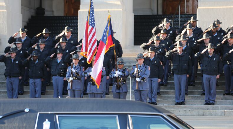 A funeral procession for former Georgia Gov. Carl Sanders stopped at the statehouse on its way to his native Augusta for a private burial Wednesday morning.