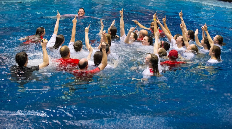 Georgia swimmers, coaches and managers celebrate their team championship in the diving well at the NCAA college women's swimming and diving championships, Saturday, March 23, 2013, in Indianapolis. (AP Photo/Doug McSchooler)